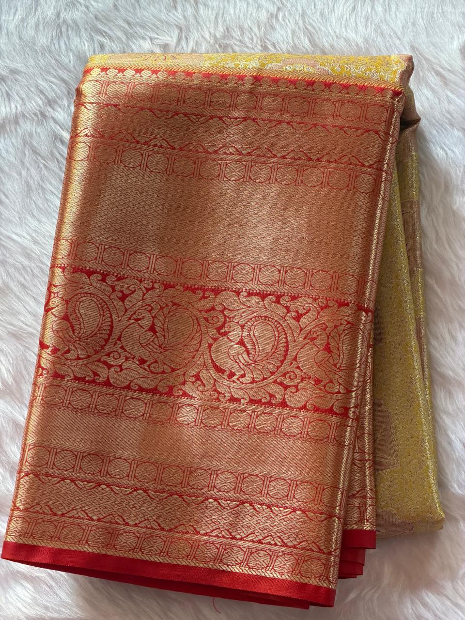 Red and gold kaddi zari border with traditional motifs on mustard yellow Kanchipuram polyester saree