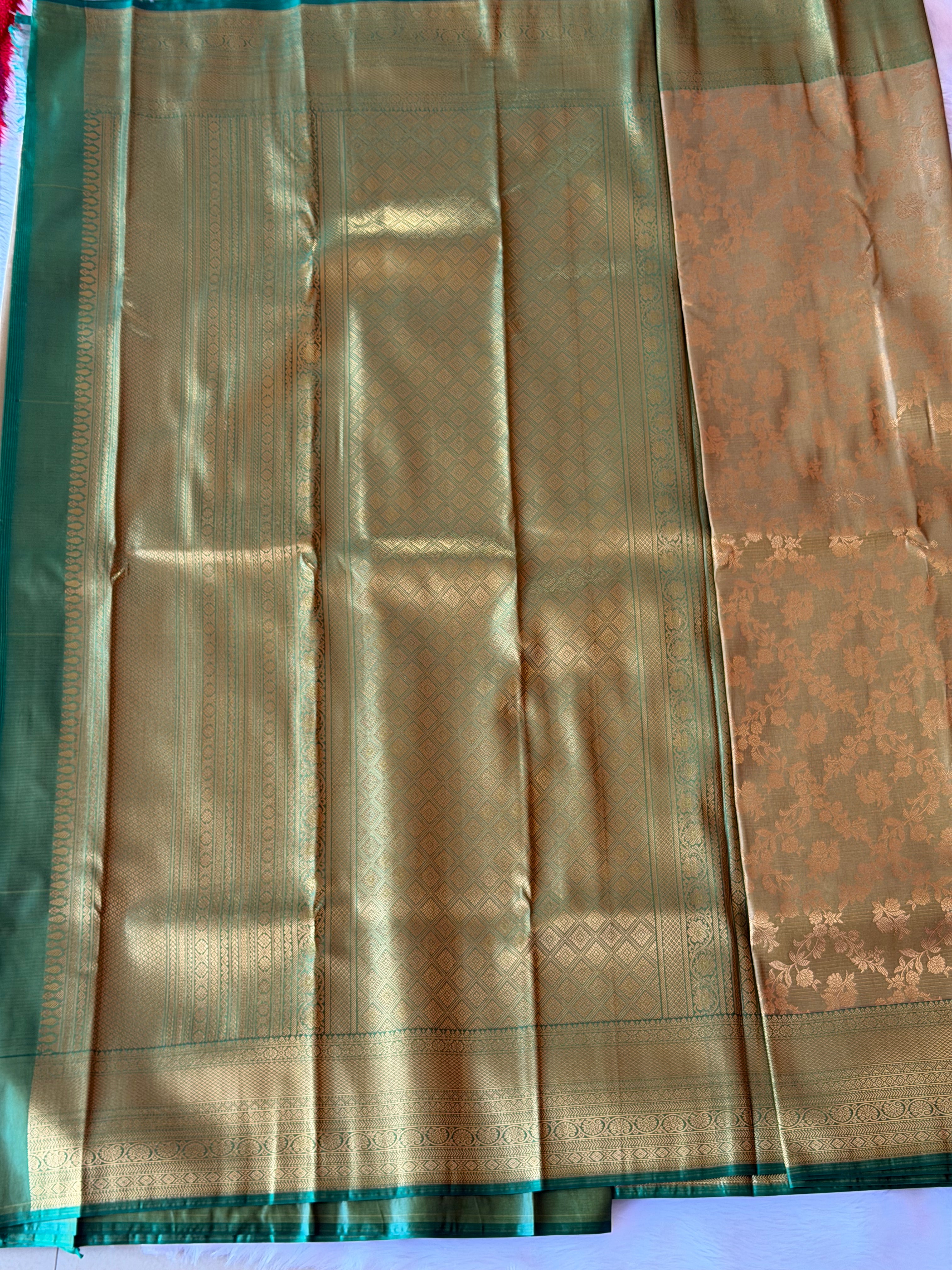 Emerald green zari contrast border with traditional motifs on olive gold Kanchipuram polyester saree