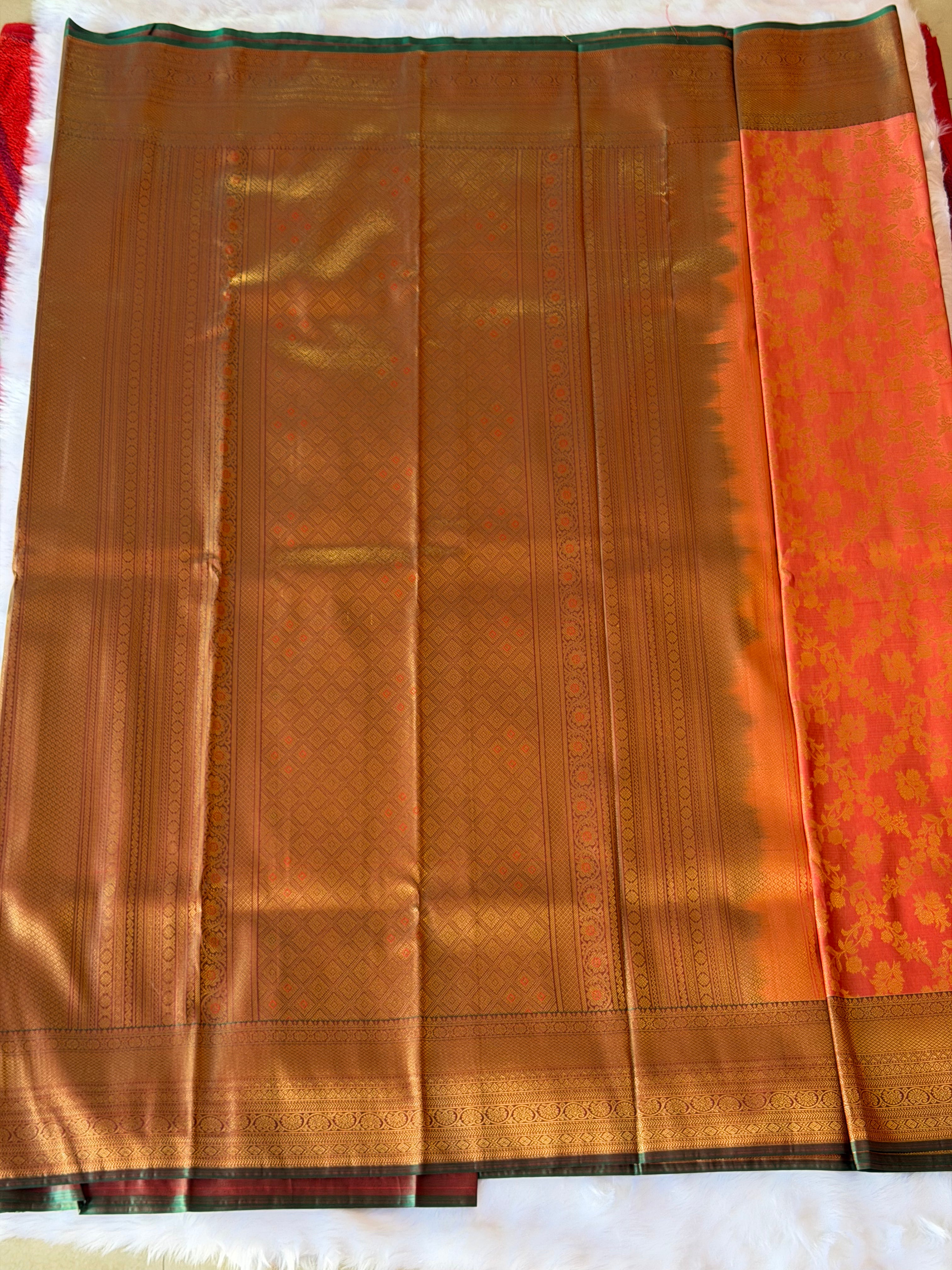 Traditional geometric patterned zari border on soft peach Kanchipuram polyester saree