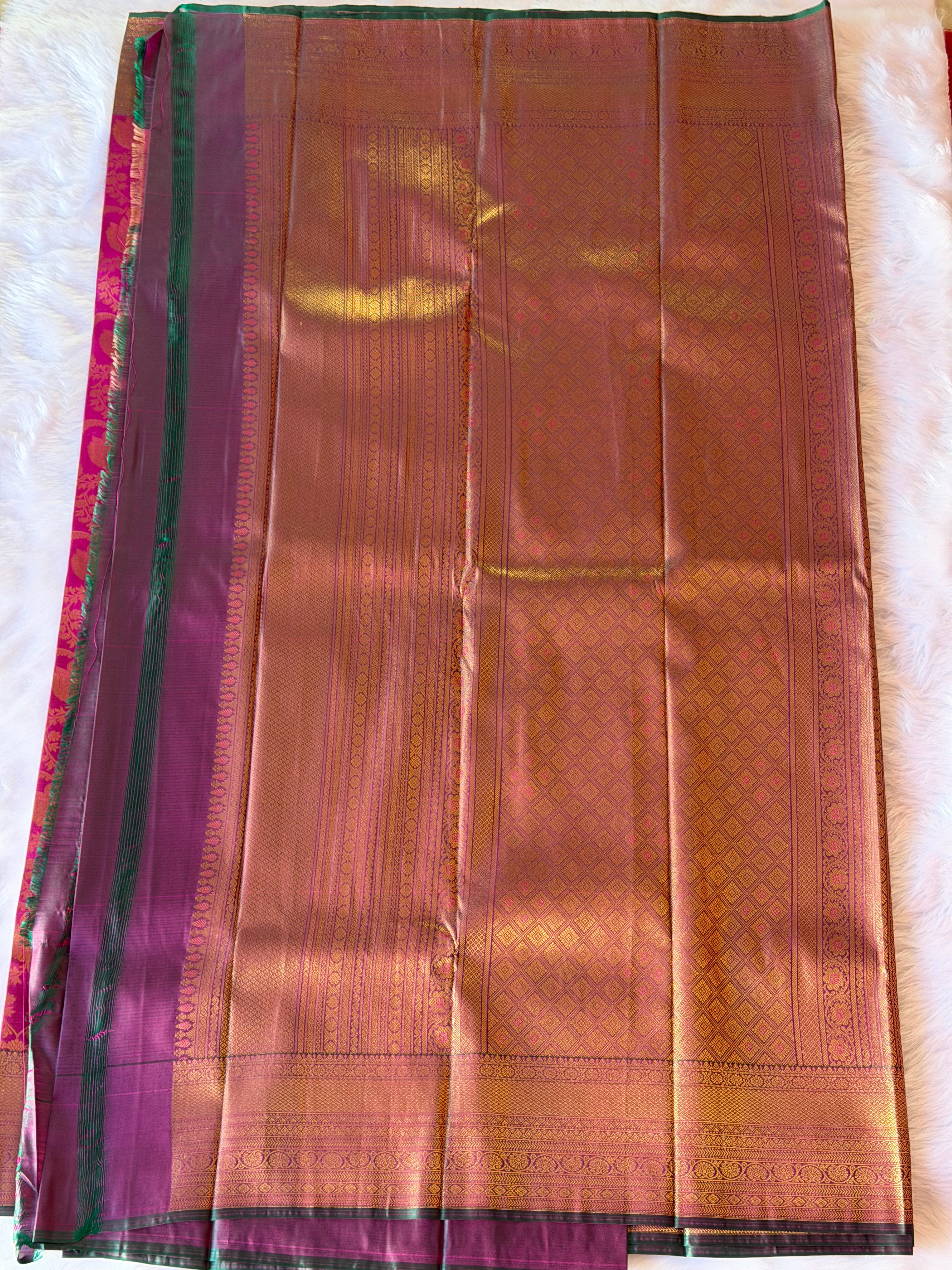 Contrasting forest green zari border on royal magenta Kanchipuram polyester saree