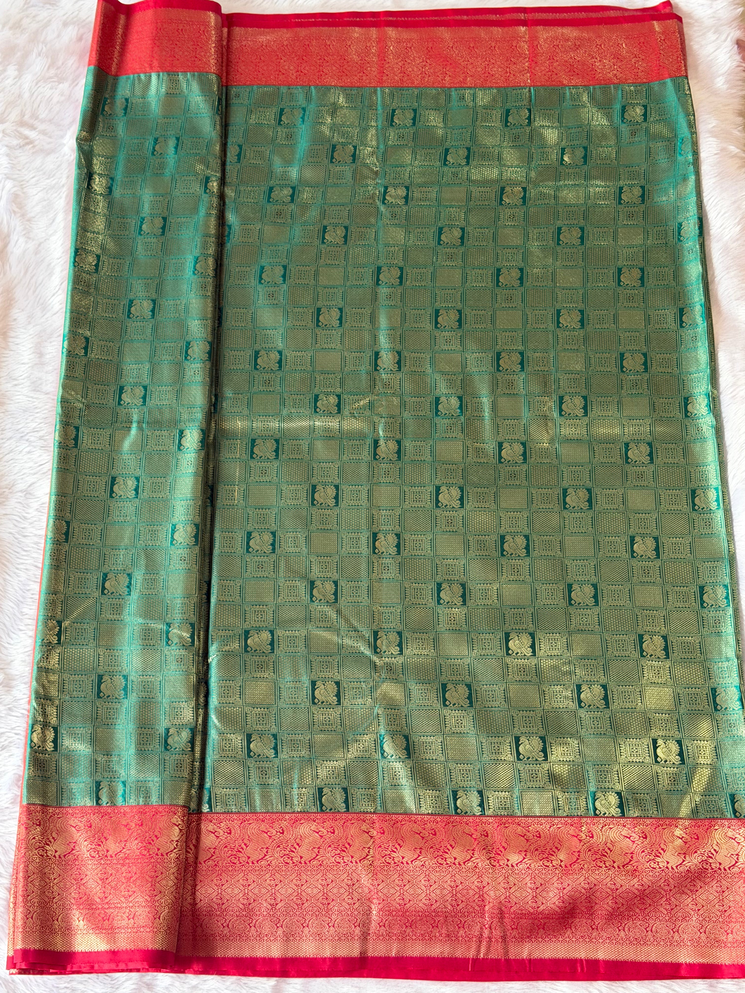 Rich crimson red contrast border with ornamental motifs on emerald green Kanchipuram polyester saree