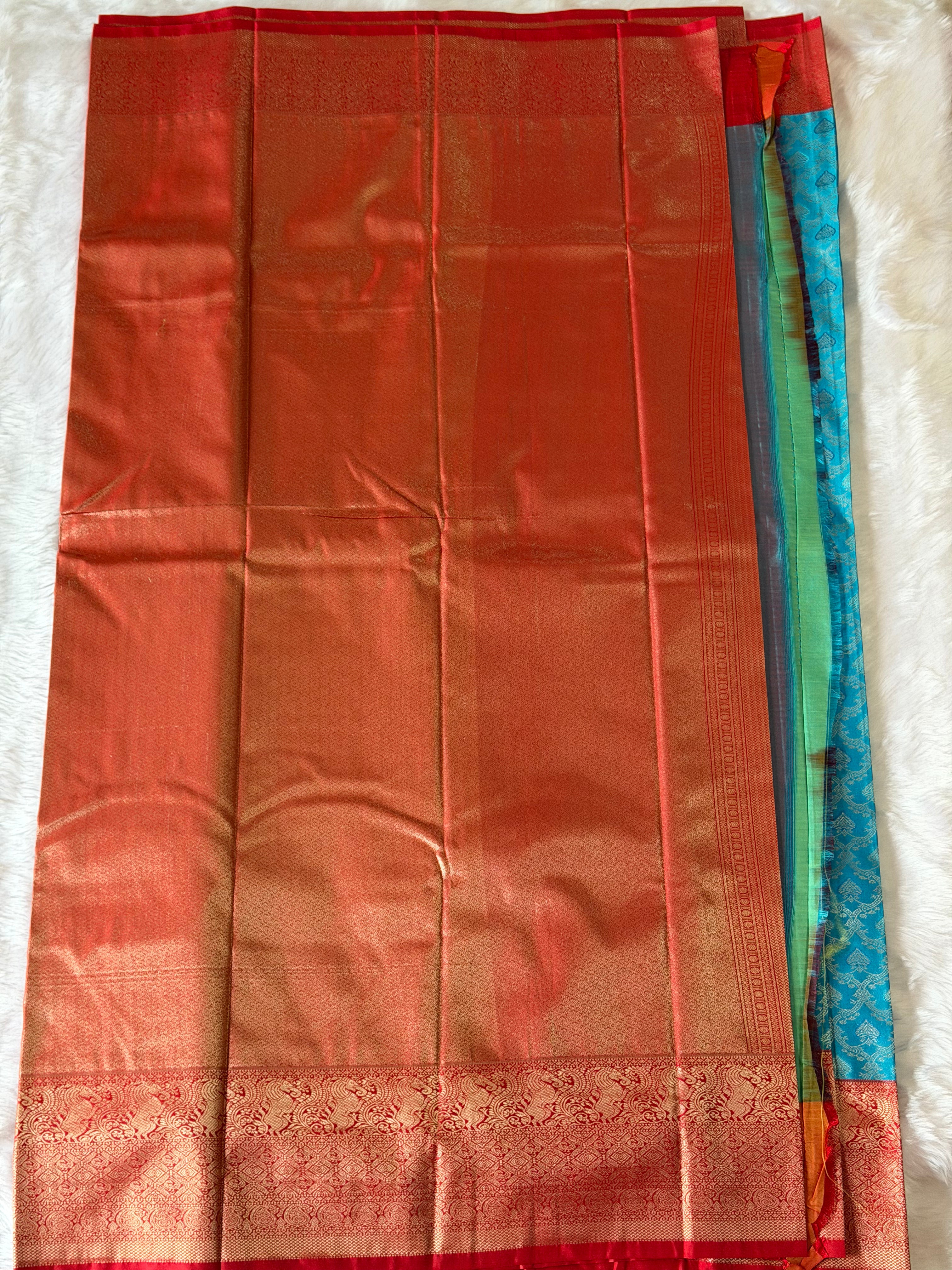 Red floral brocade contrast border on teal blue Kanchipuram polyester saree