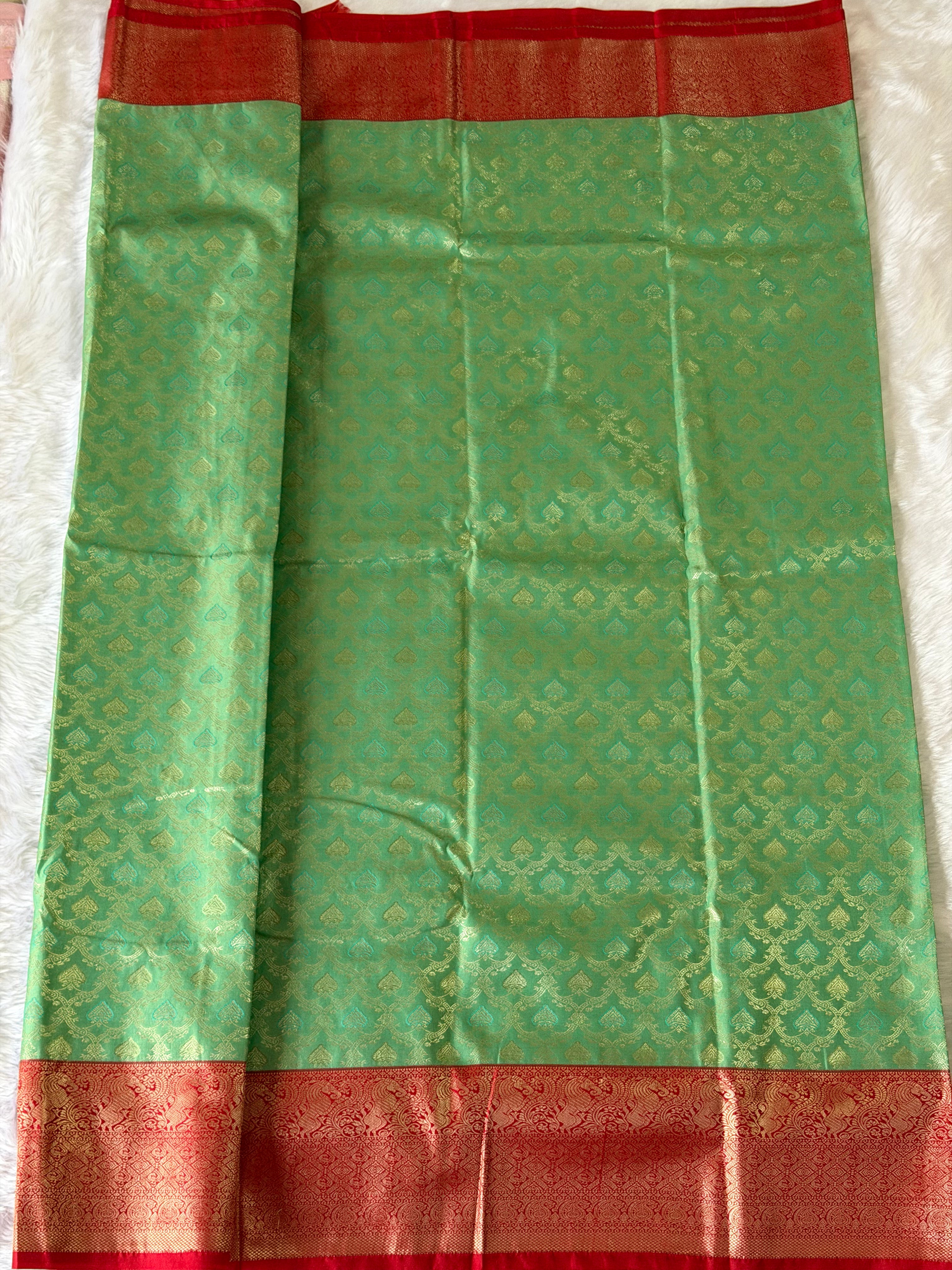 Crimson red traditional zari border on seafoam green Kanchipuram polyester saree