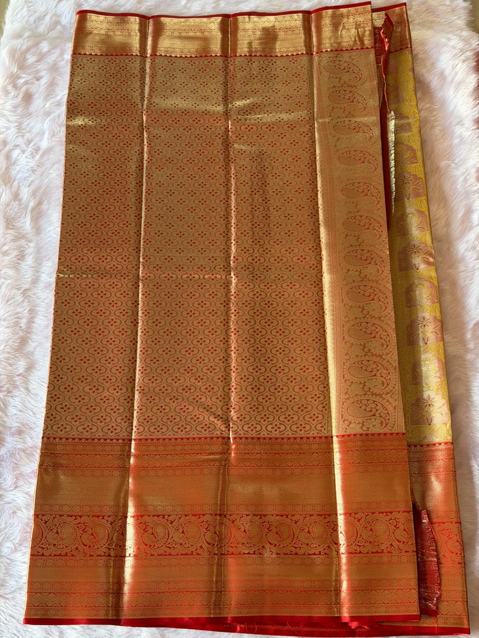 Pallu detail of mustard yellow Kanchipuram polyester saree with gold zari work